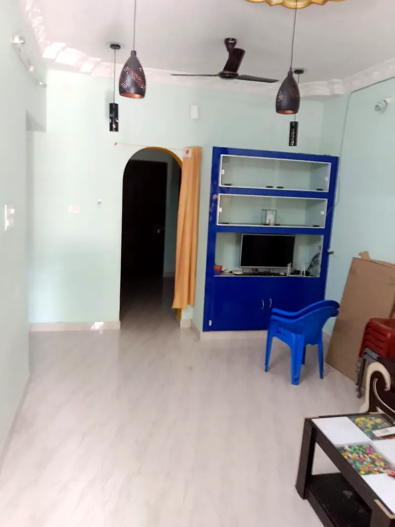 Living hall with TV cabinet and ceiling fan at Uddish Residency