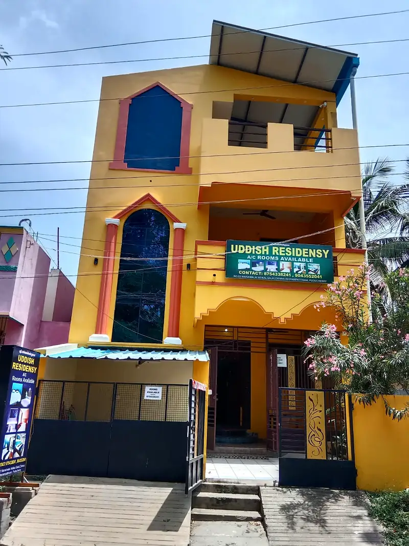 Front of Uddish Residency, a yellow guest house with A/C rooms in Chinna Veerampattinam, Pondicherry